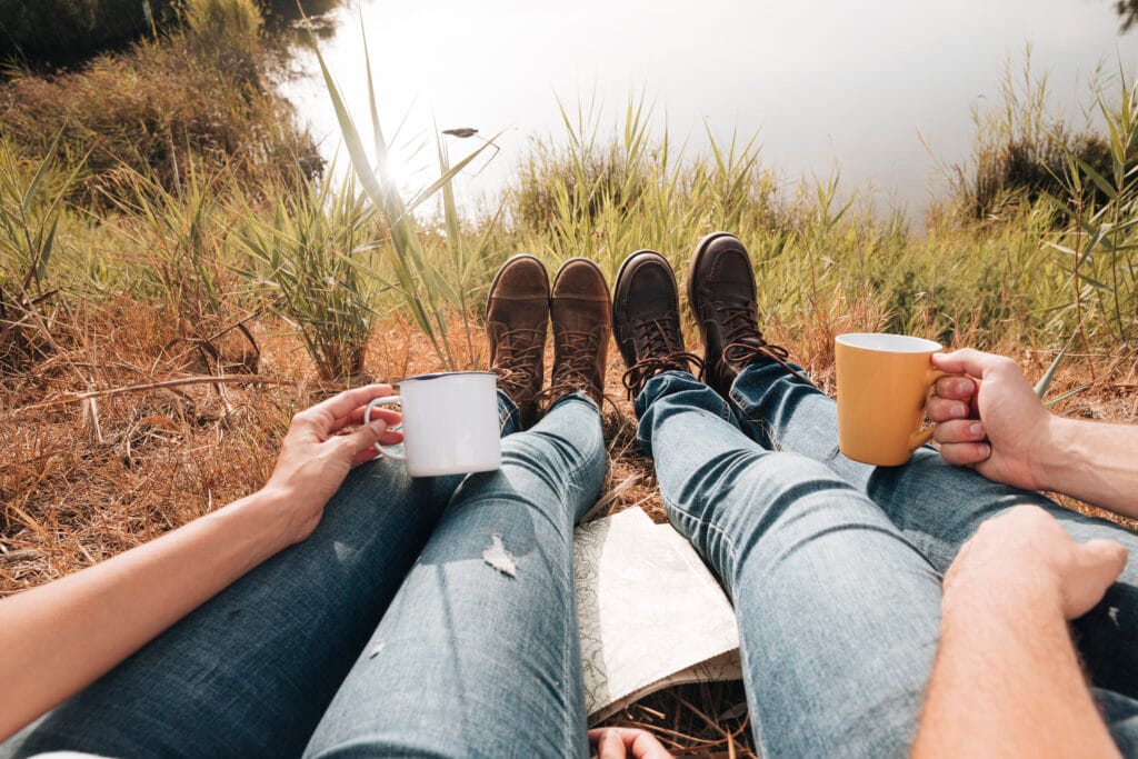 close up couple sitting lake